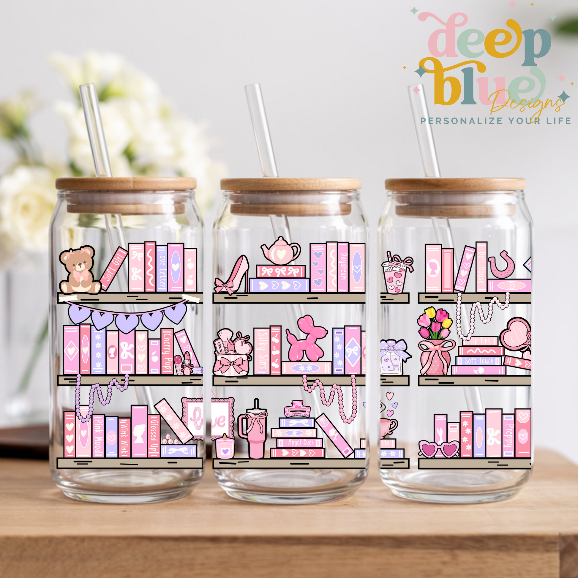 Three glass jars with wooden lids and pink-themed illustrations on a wooden surface.