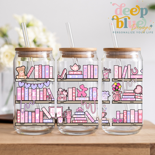 Three glass jars with wooden lids and pink-themed illustrations on a wooden surface.