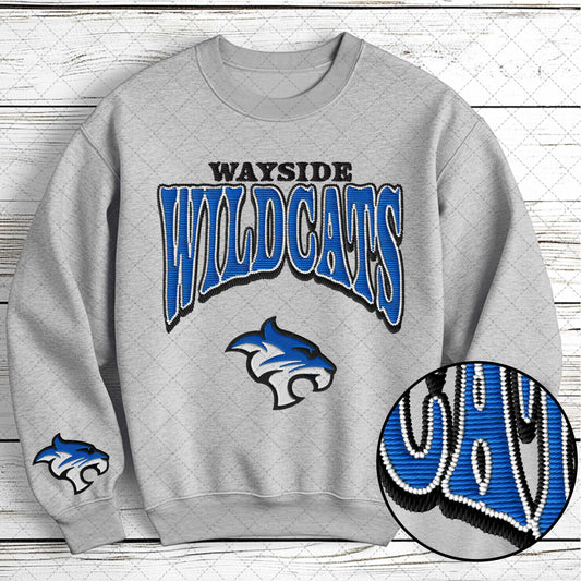 Gray sweatshirt with 'Wayside Wildcats' text and logo on a wooden background